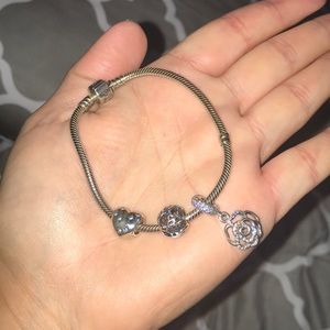 Authentic pandora bracelet with three charms.